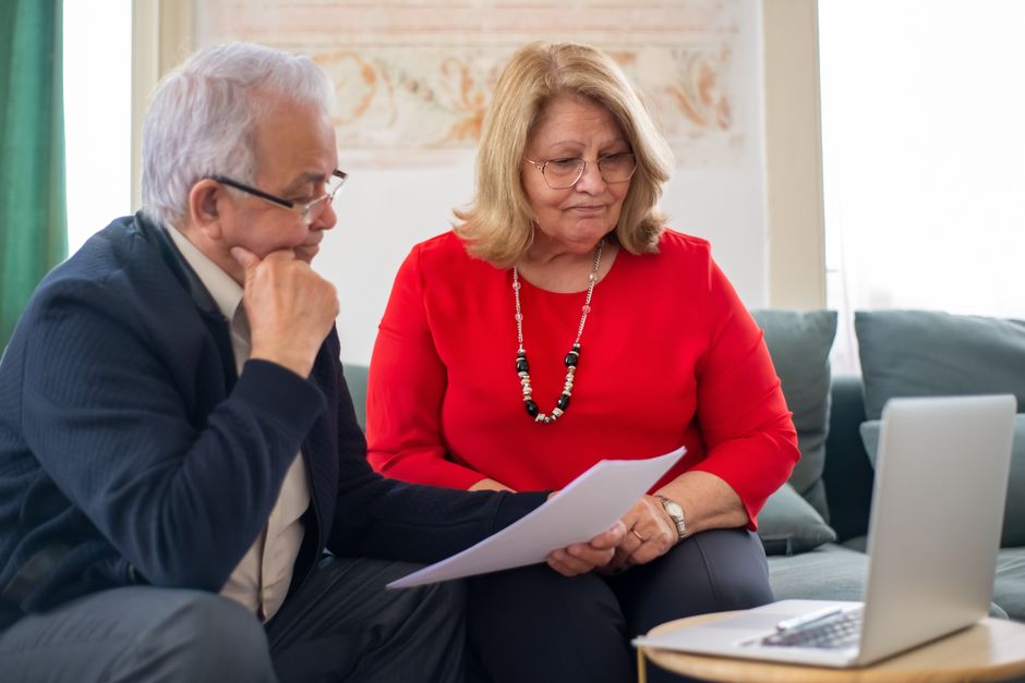 Retired couple reviewing paperwork while comparing Medigap Plan G vs Plan N
